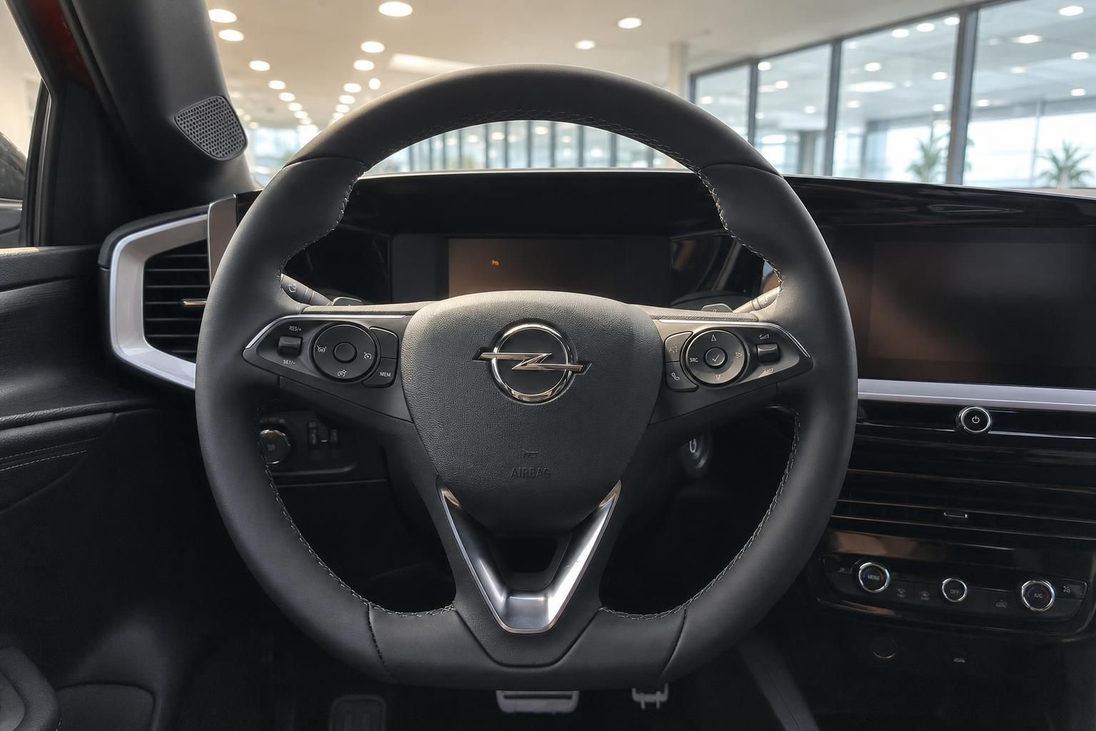 Opel Lenkrad mit Multifunktionstasten und Instrumentendisplay im Fahrzeug-Cockpit