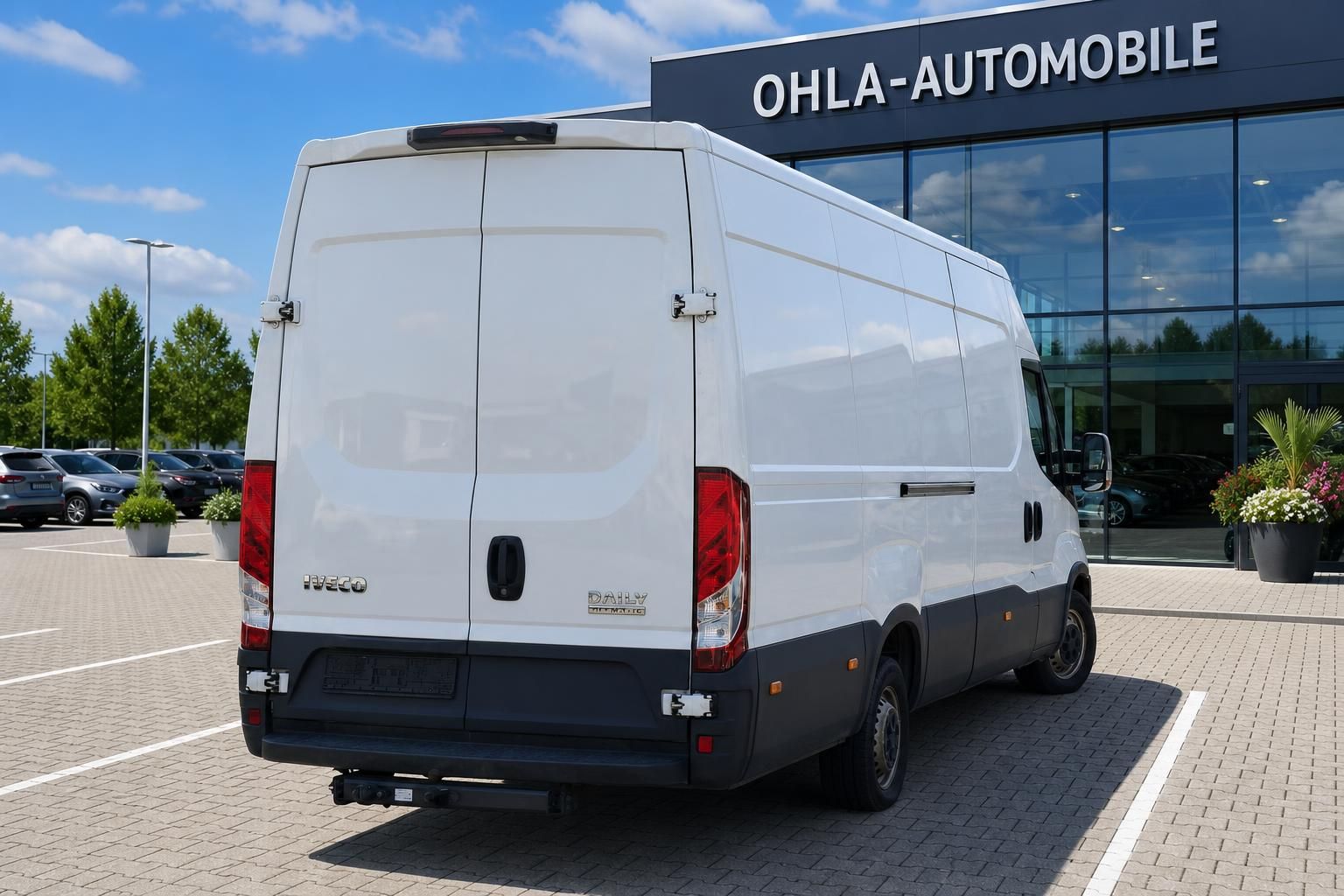 Iveco Daily Transporter weiß Heck-Seitenansicht vor Autohaus