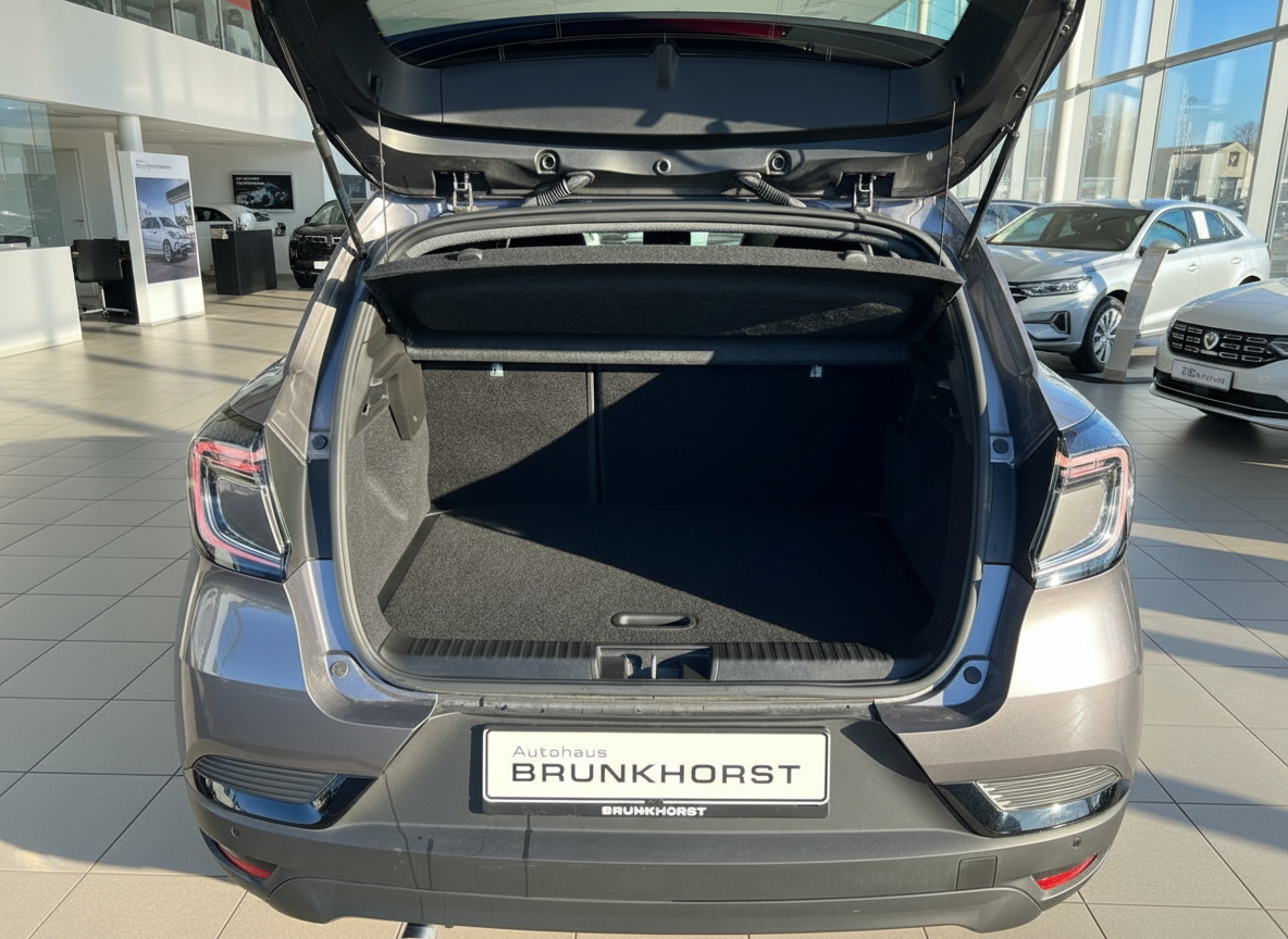 Grauer Kompaktwagen mit geöffnetem Kofferraum im Autohaus Brunkhorst Showroom