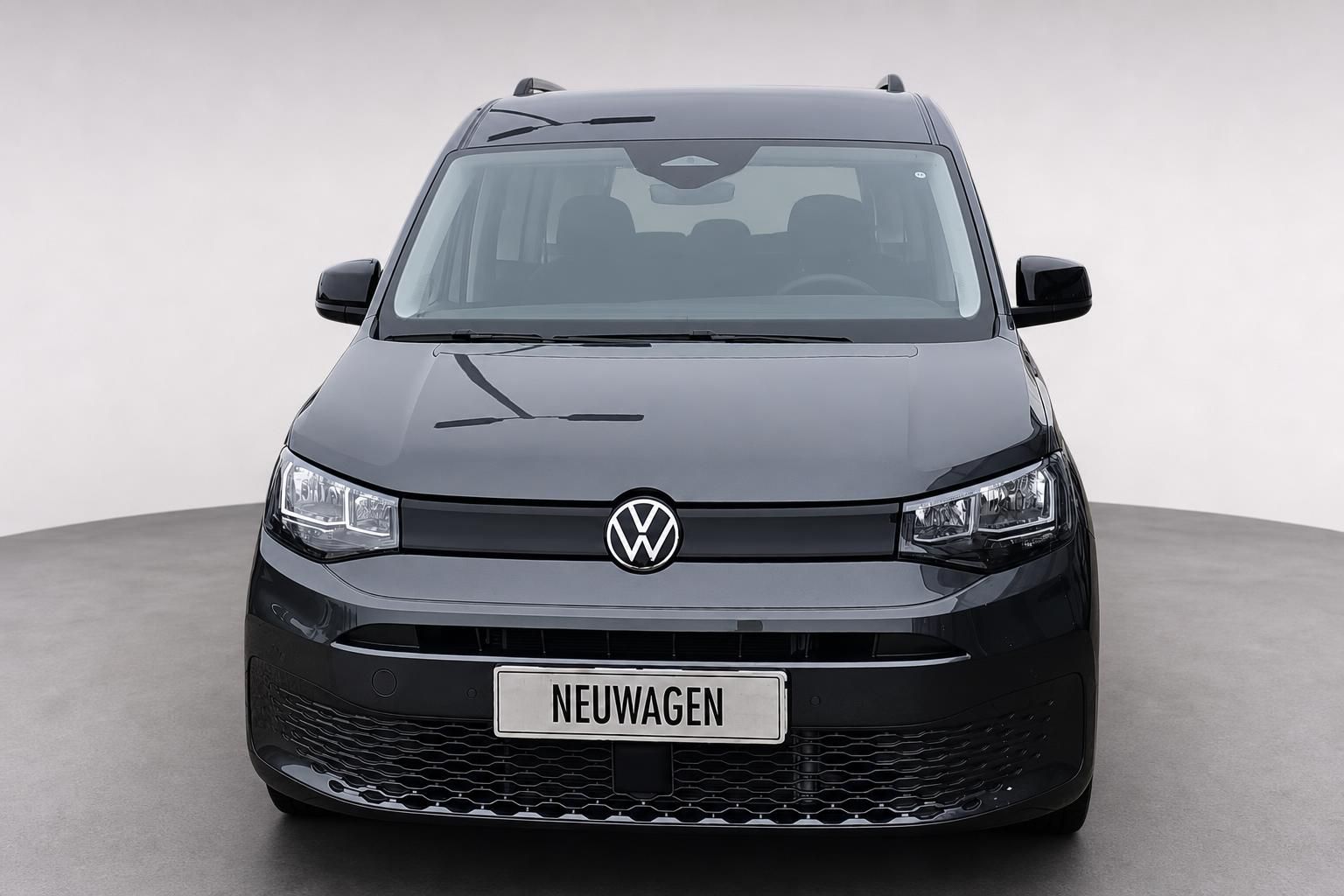 VW Caddy grau, Frontansicht mit VW Logo und Scheinwerfern