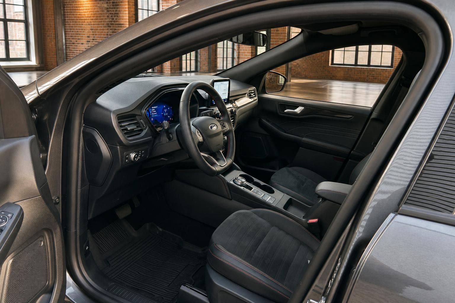 Ford Innenraum mit Cockpit, Lenkrad und Sportsitzen bei geoeffneter Fahrertuer