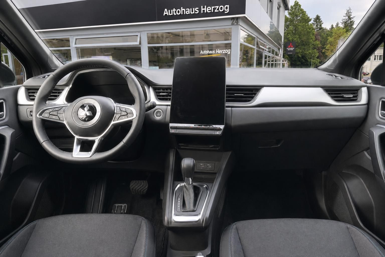 Fahrzeug Cockpit mit Lenkrad, Armaturenbrett und zentralem Touchscreen Display