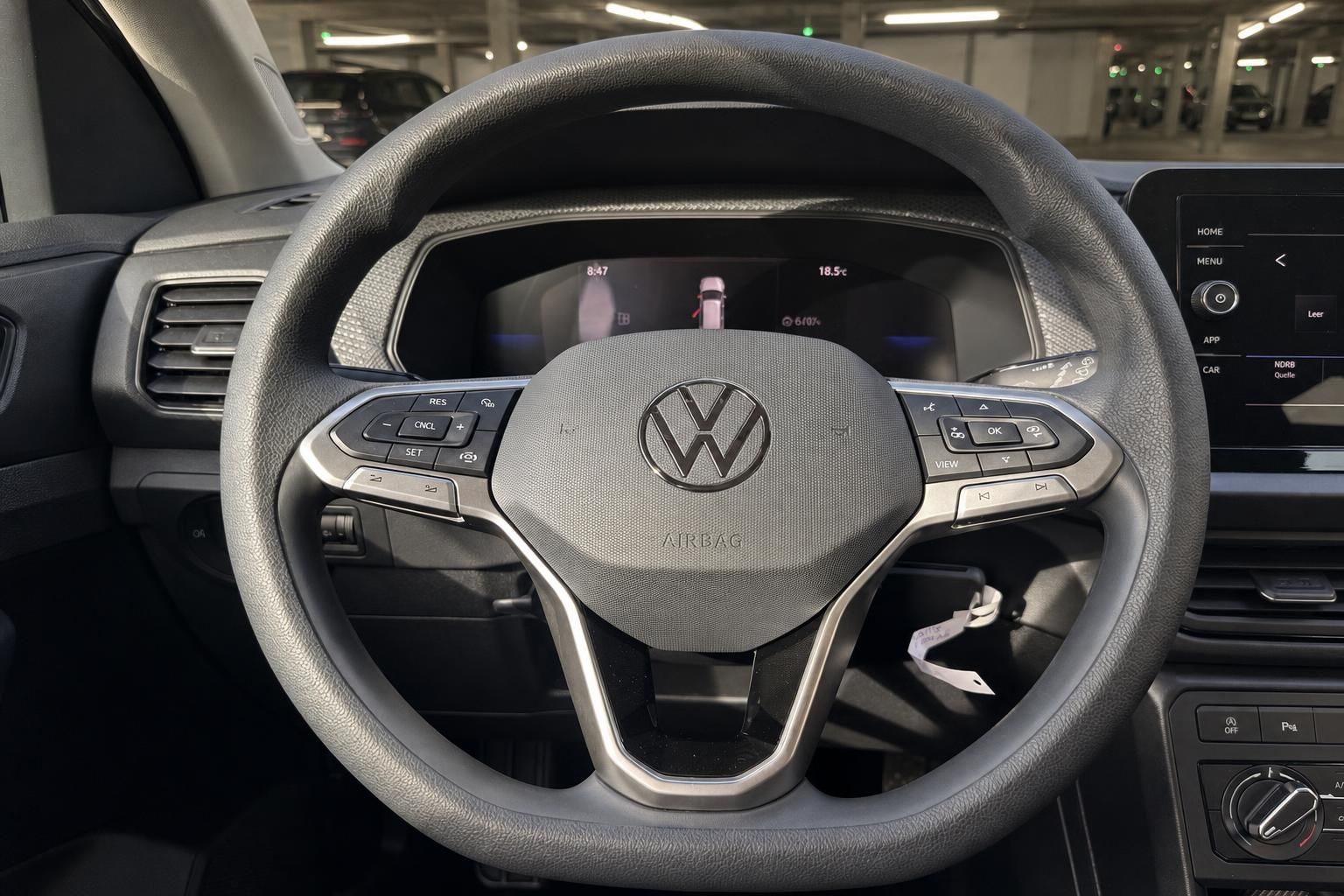 VW T-Cross Lenkrad mit Multifunktionstasten, Airbag und Digitaldisplay im Hintergrund