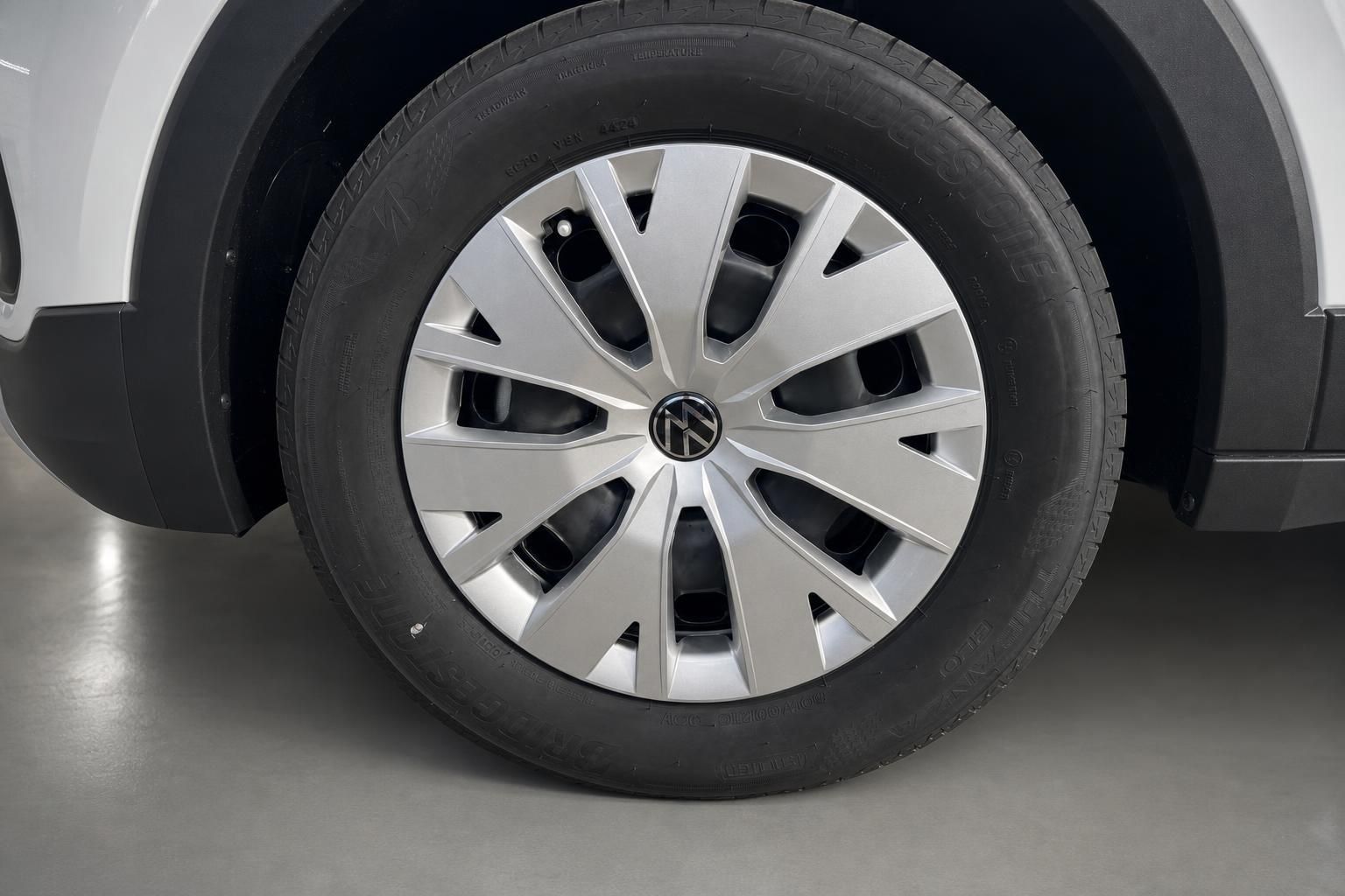 VW Stahlfelge mit Radkappe und Sommerreifen an weißem VW SUV Fahrzeug
