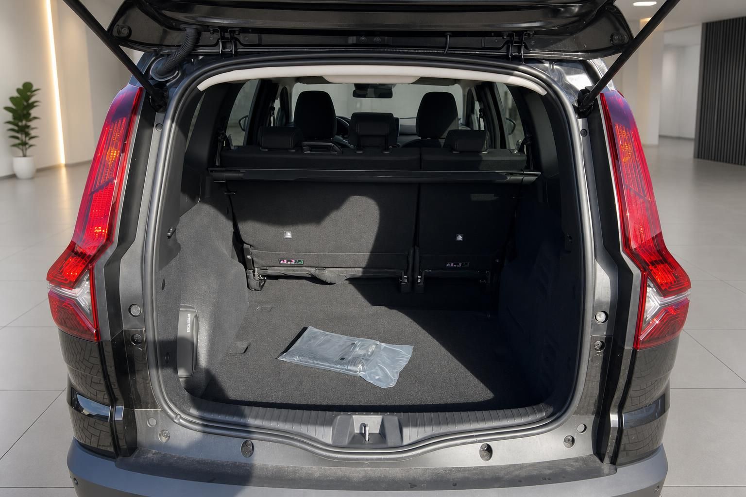 Geräumiger Kofferraum eines grauen SUV mit geöffneter Heckklappe und umgeklappten Rücksitzen