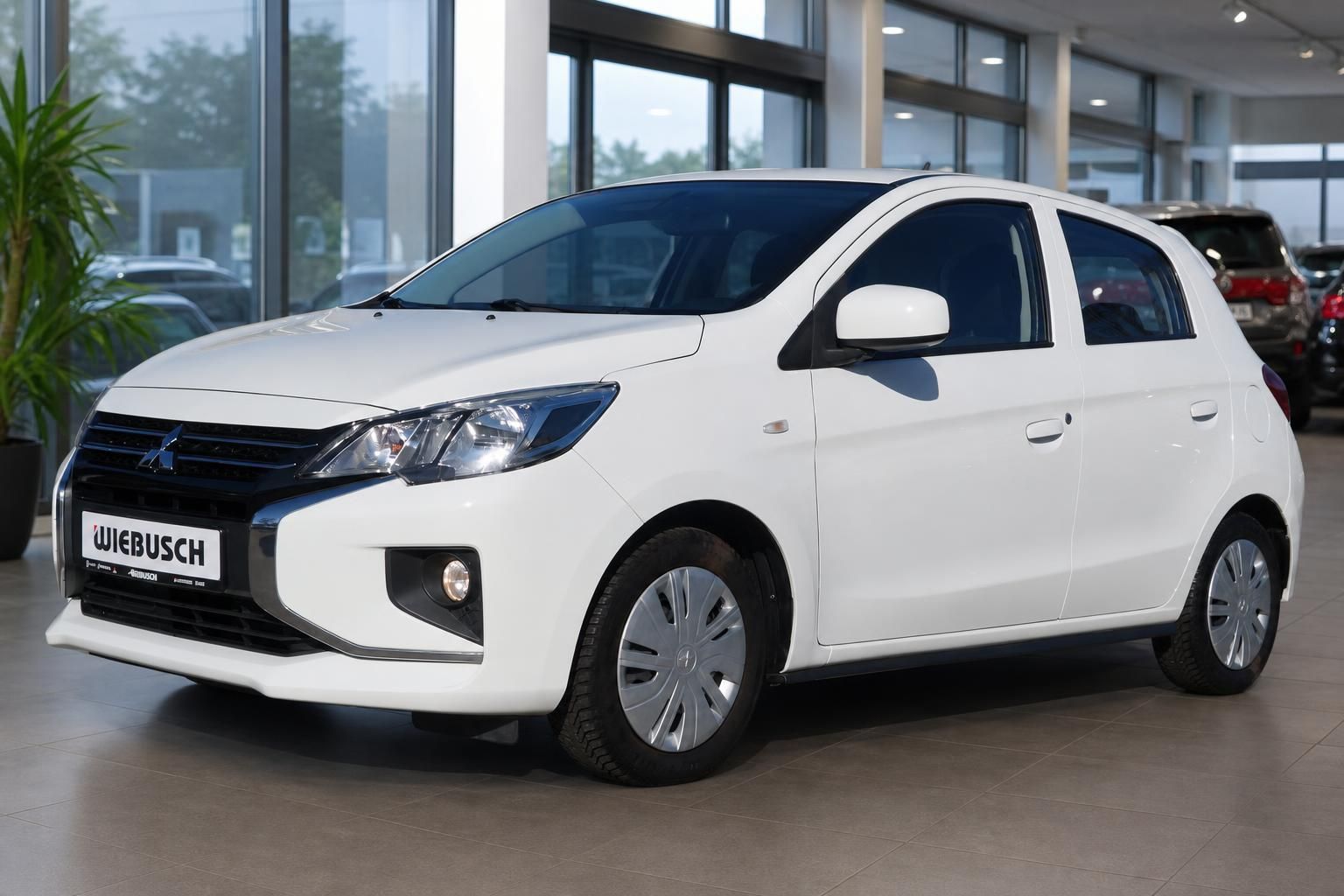 Weißer Mitsubishi Space Star Kleinwagen Frontansicht drei Viertel im Autohaus