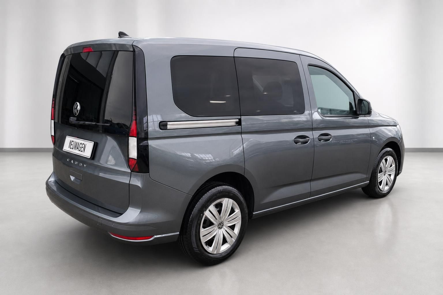 VW Caddy Grau Seitenansicht hinten mit Felgen und Fenstern