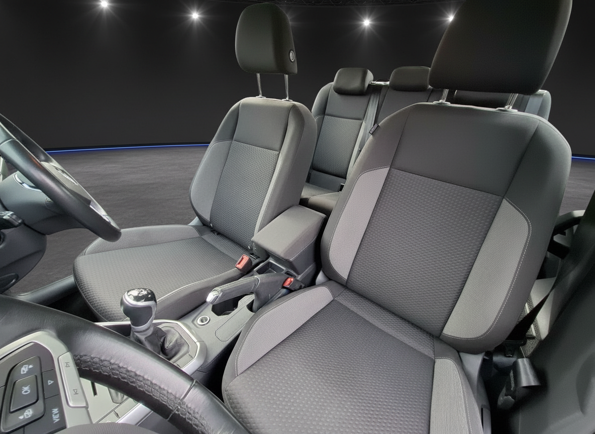 Fahrzeuginnenraum mit grauen Stoffsitzen, Mittelkonsole und Schaltgetriebe