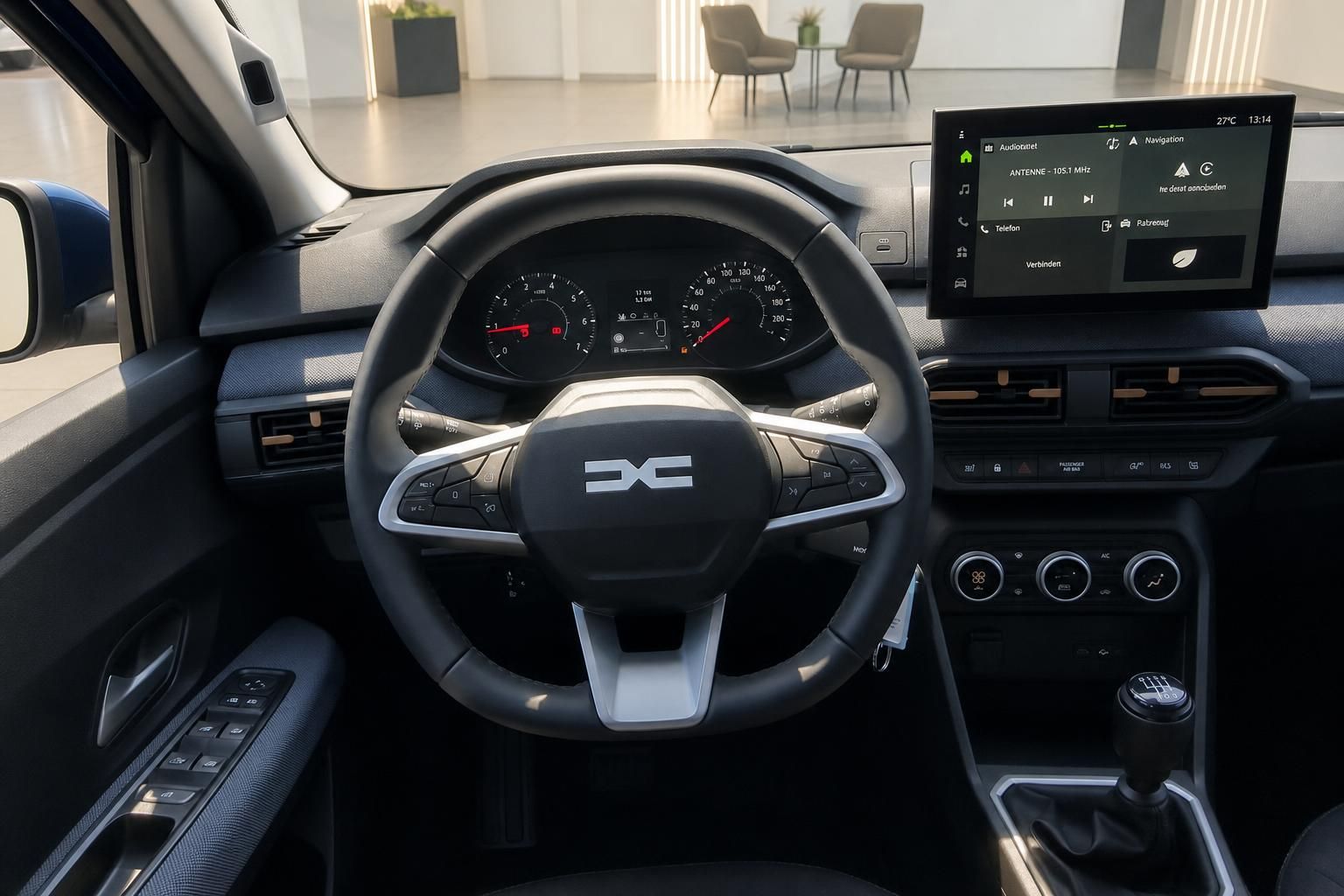 Cockpit mit Lenkrad, Tacho und Infotainment-Display im Fahrzeuginnenraum