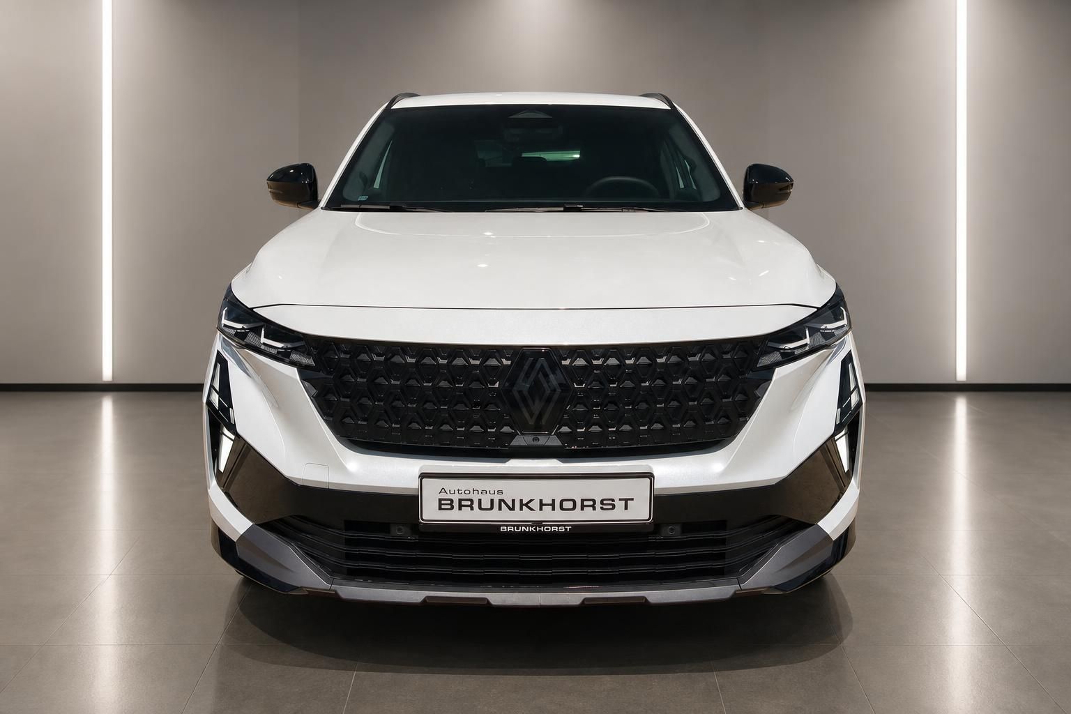 Renault Austral weiss, Frontalansicht mit Kuehlergrill im Showroom