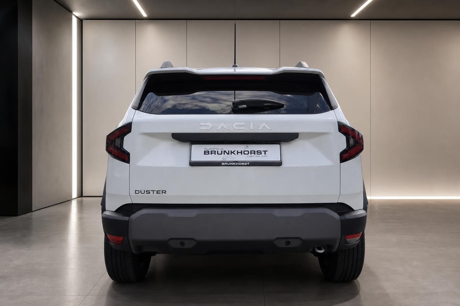 Dacia Duster weiß Heckansicht in modernem Autohaus Showroom