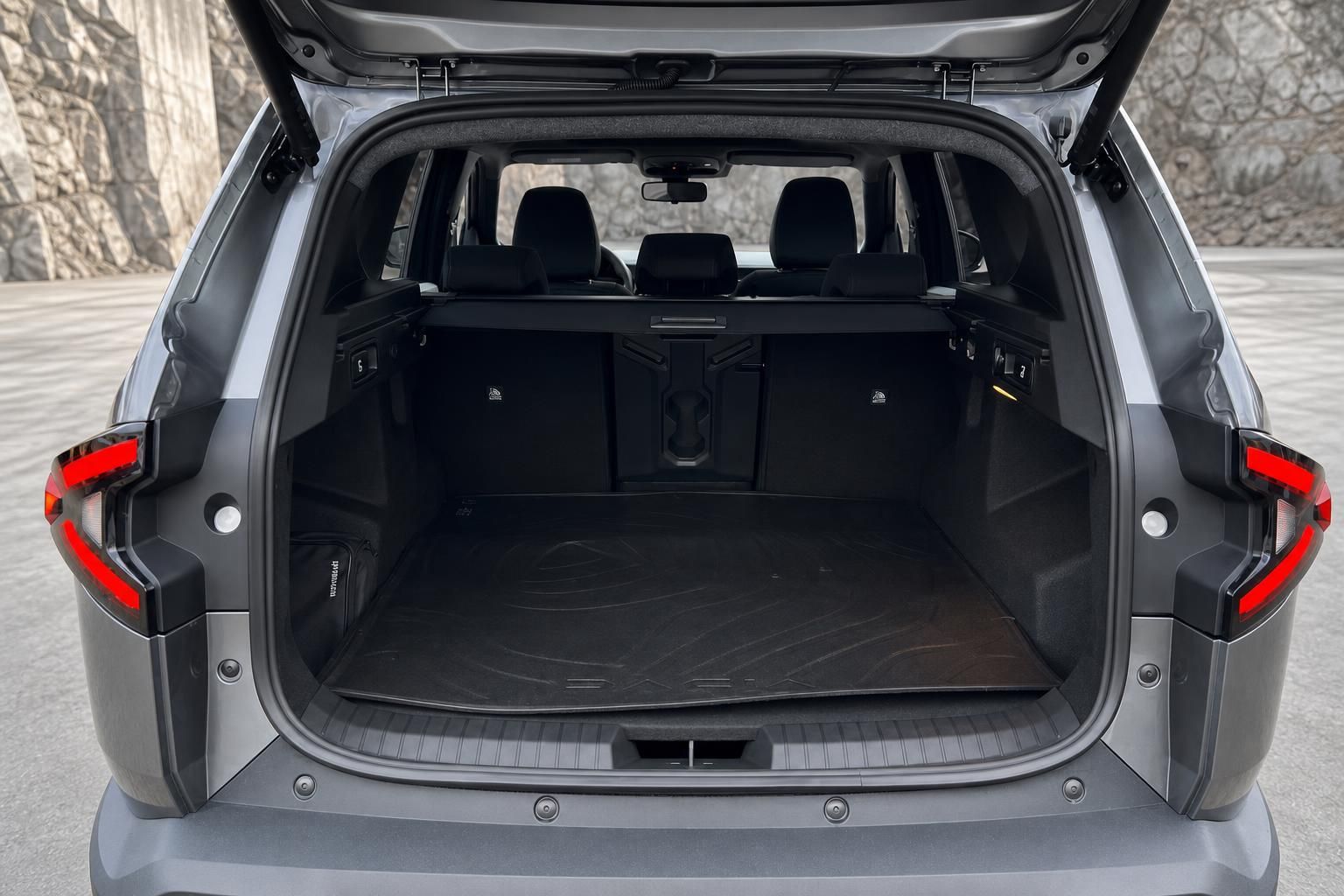 Geräumiger Kofferraum eines grauen SUV mit geöffneter Heckklappe und schwarzer Innenausstattung