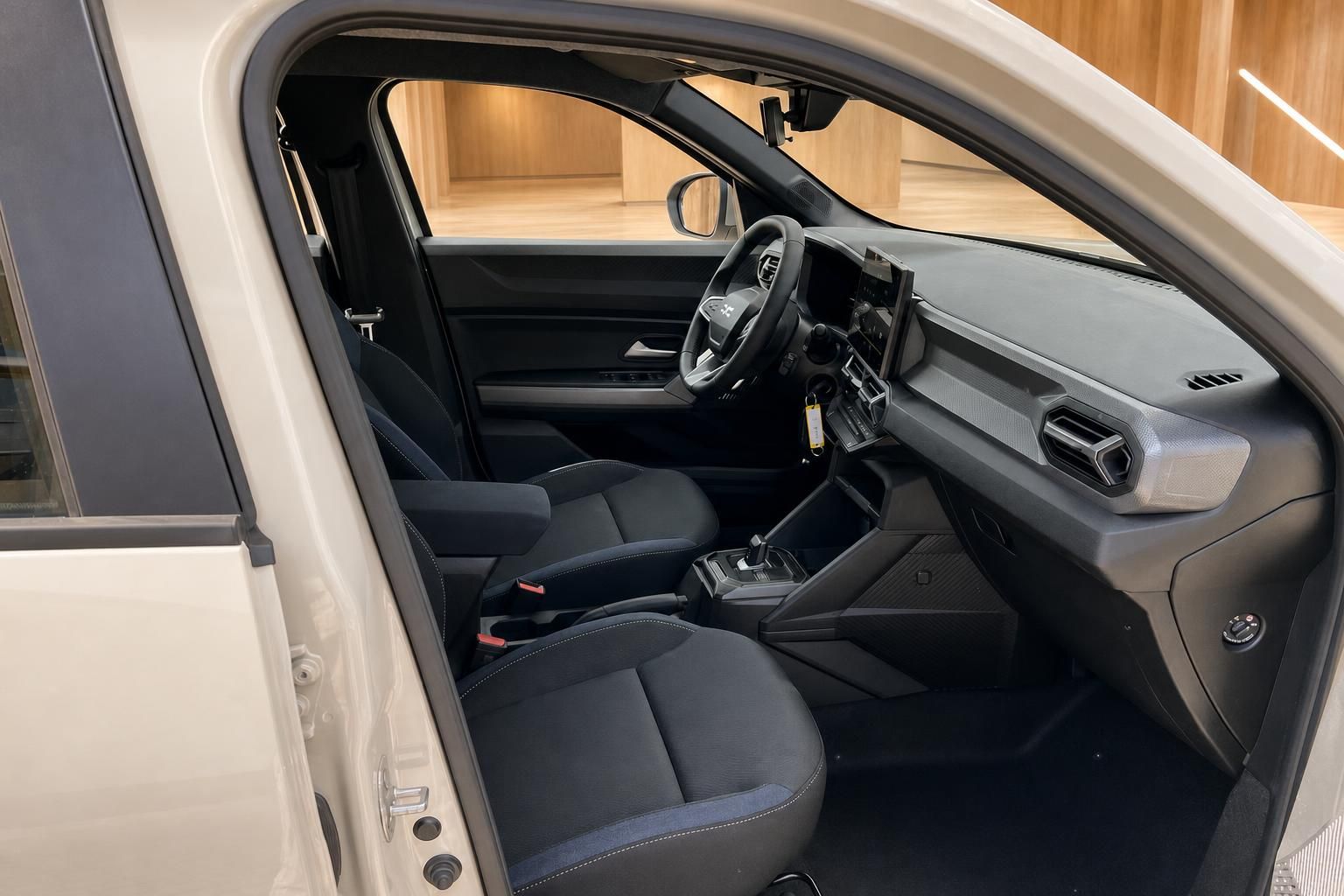 Innenraum Dacia mit Vordersitzen und Cockpit, Blick durch geoeffnete Fahrertuer