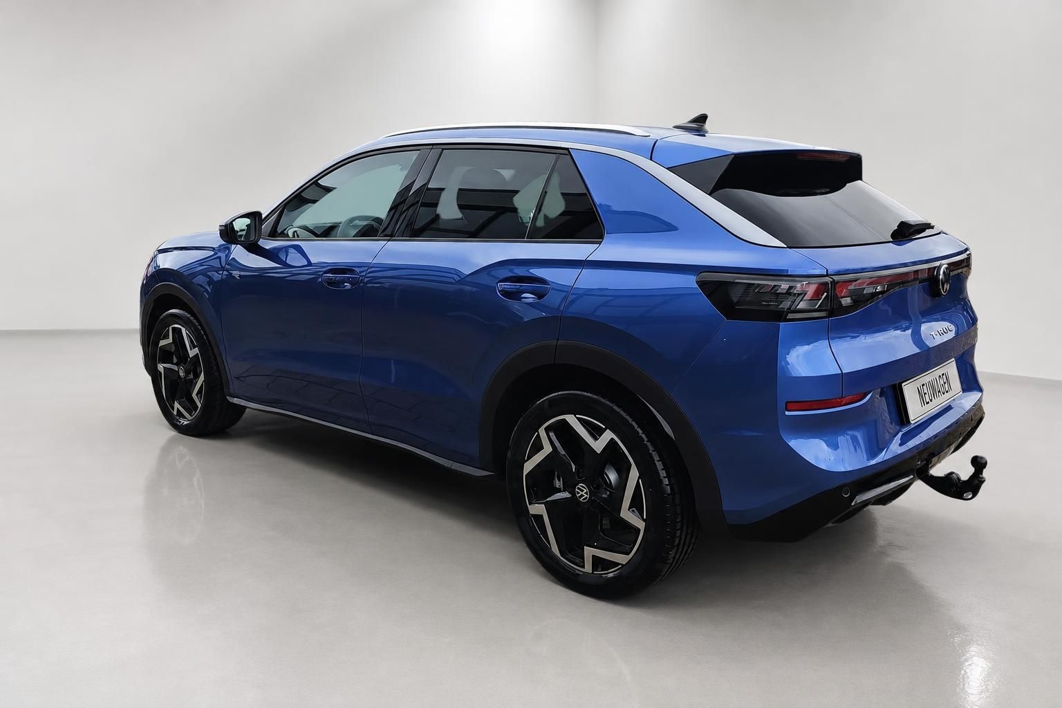VW T-Roc blau, Heckansicht schraeg von hinten im Studio