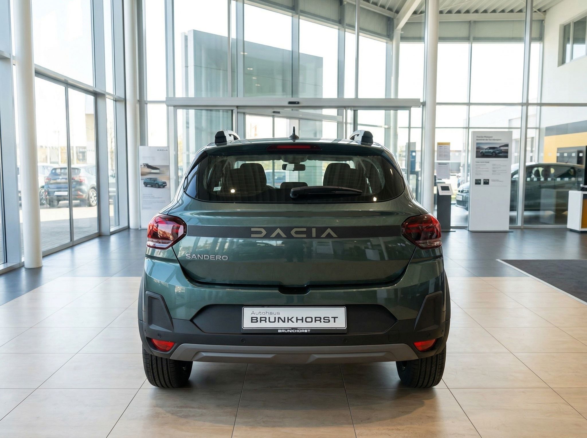 Dacia Sandero in grün-metallic Heckansicht im Autohaus mit Kennzeichen