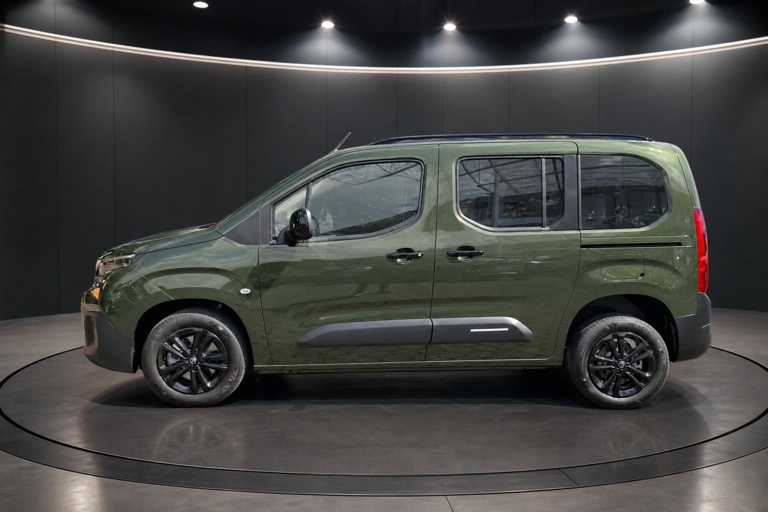 Citroën Berlingo grün Seitenansicht links mit schwarzen Felgen im Showroom