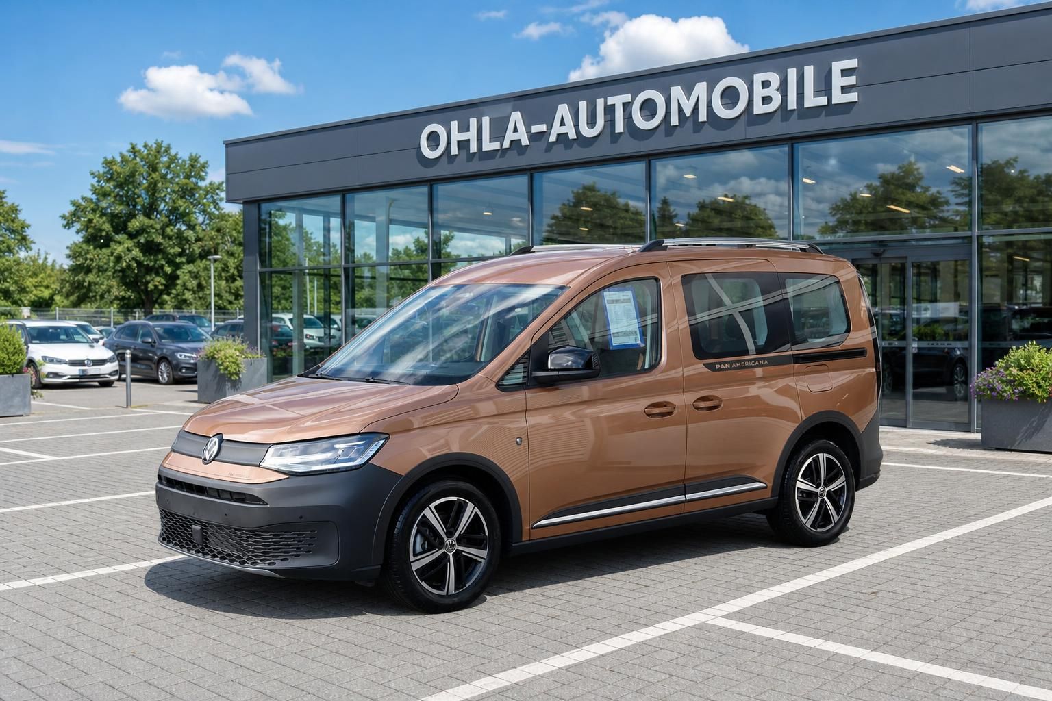 VW Caddy Pan Americana in Bronze vor Autohaus Ohla-Automobile