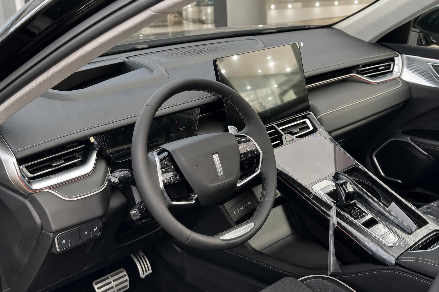 Fahrzeuginnenraum mit Lenkrad, Mittelkonsole und Infotainment-Display