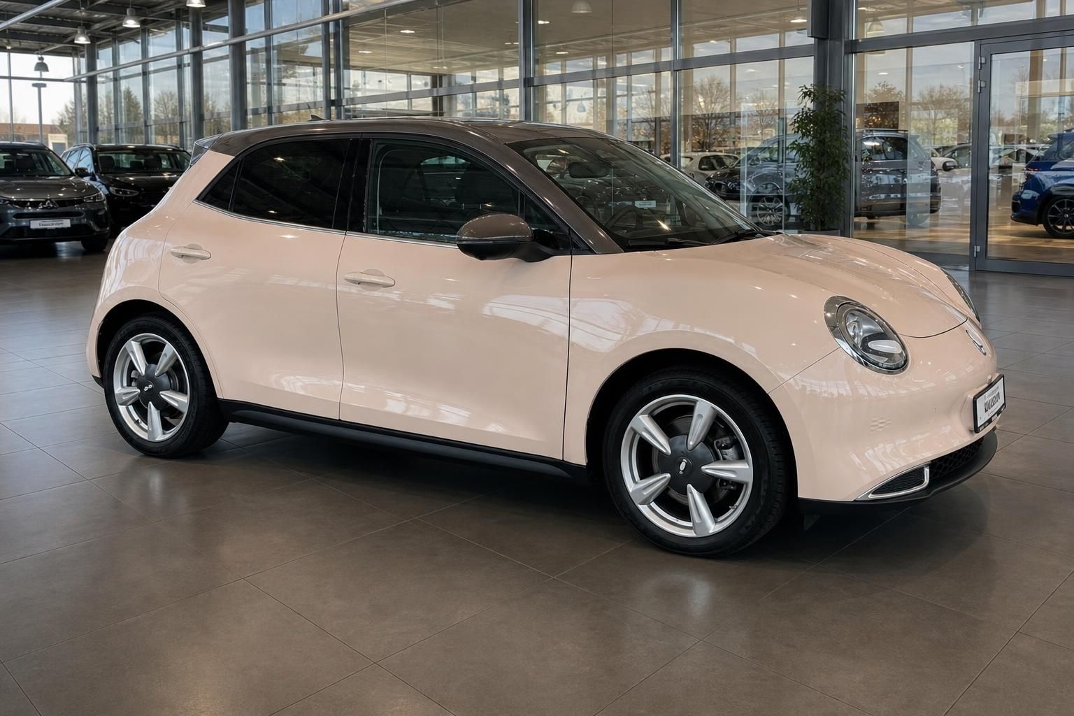 Ora Elektroauto beige - Frontansicht schräg mit Alufelgen im Autohaus Showroom
