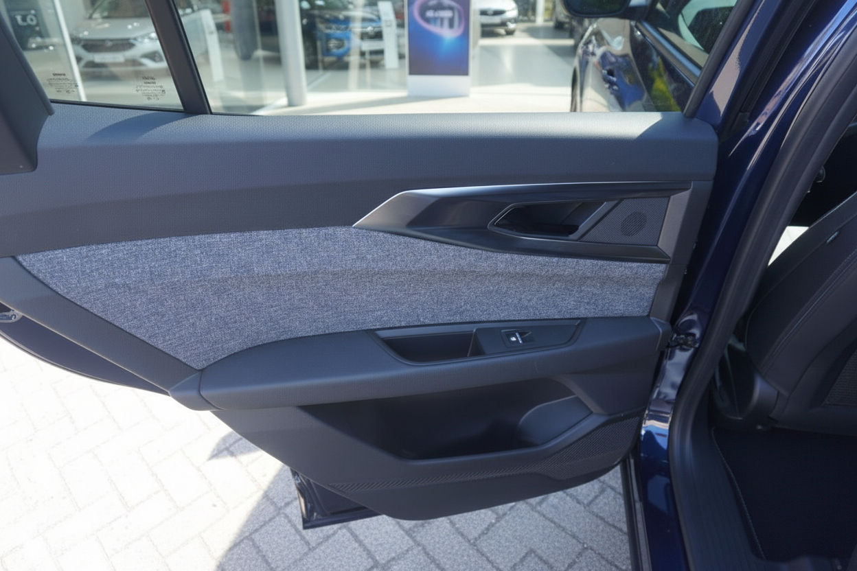 Fahrzeugtür Innenverkleidung in Grau mit Türgriff und Fensterheber eines blauen VW