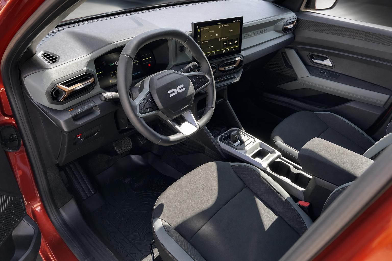 Dacia SUV Innenraum mit grauem Cockpit, Lenkrad, Touchscreen und modernen Sitzen