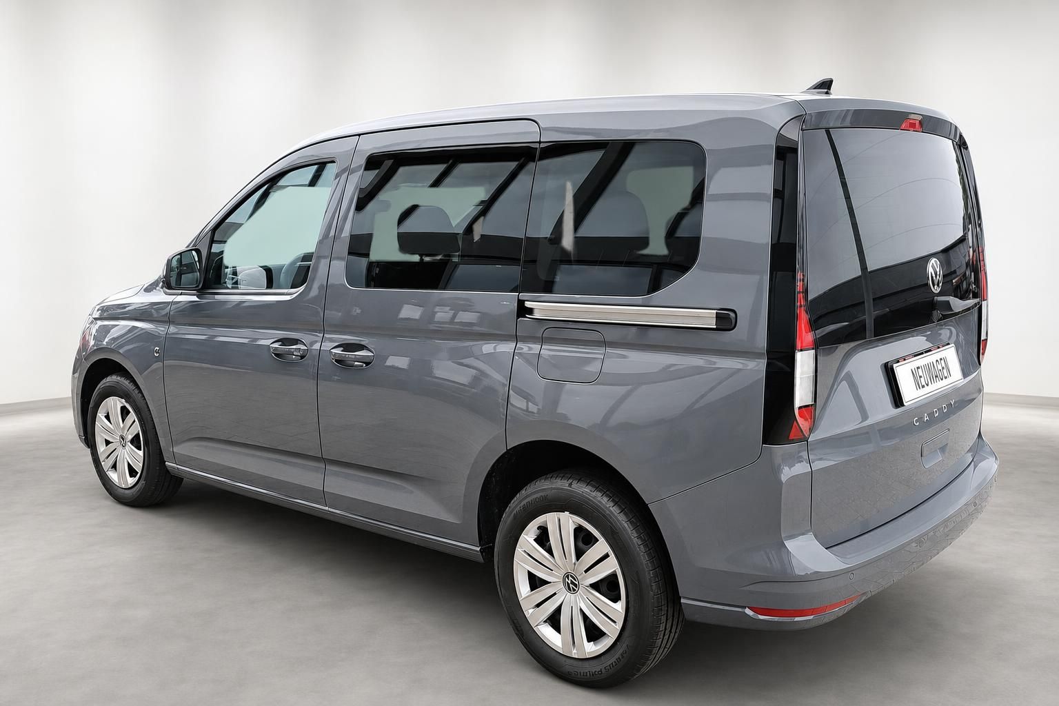 VW Caddy grau Heckansicht schraeg im Studio