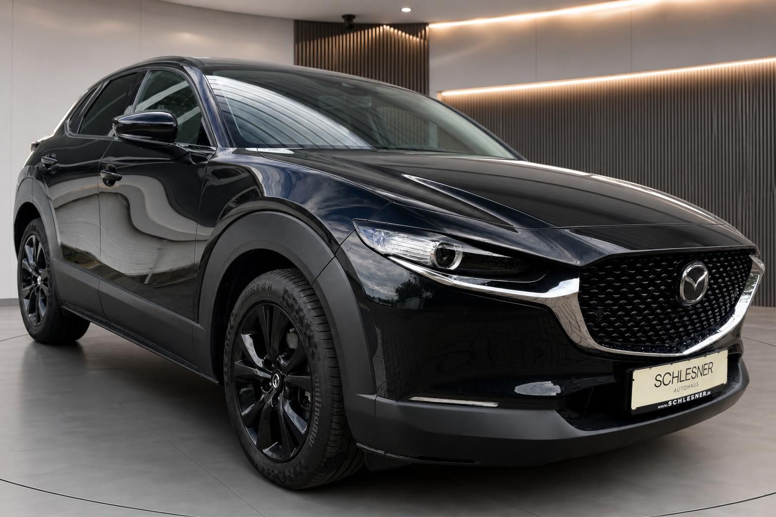 Mazda CX-30 schwarz Frontansicht schräg im Autohaus Schlesner