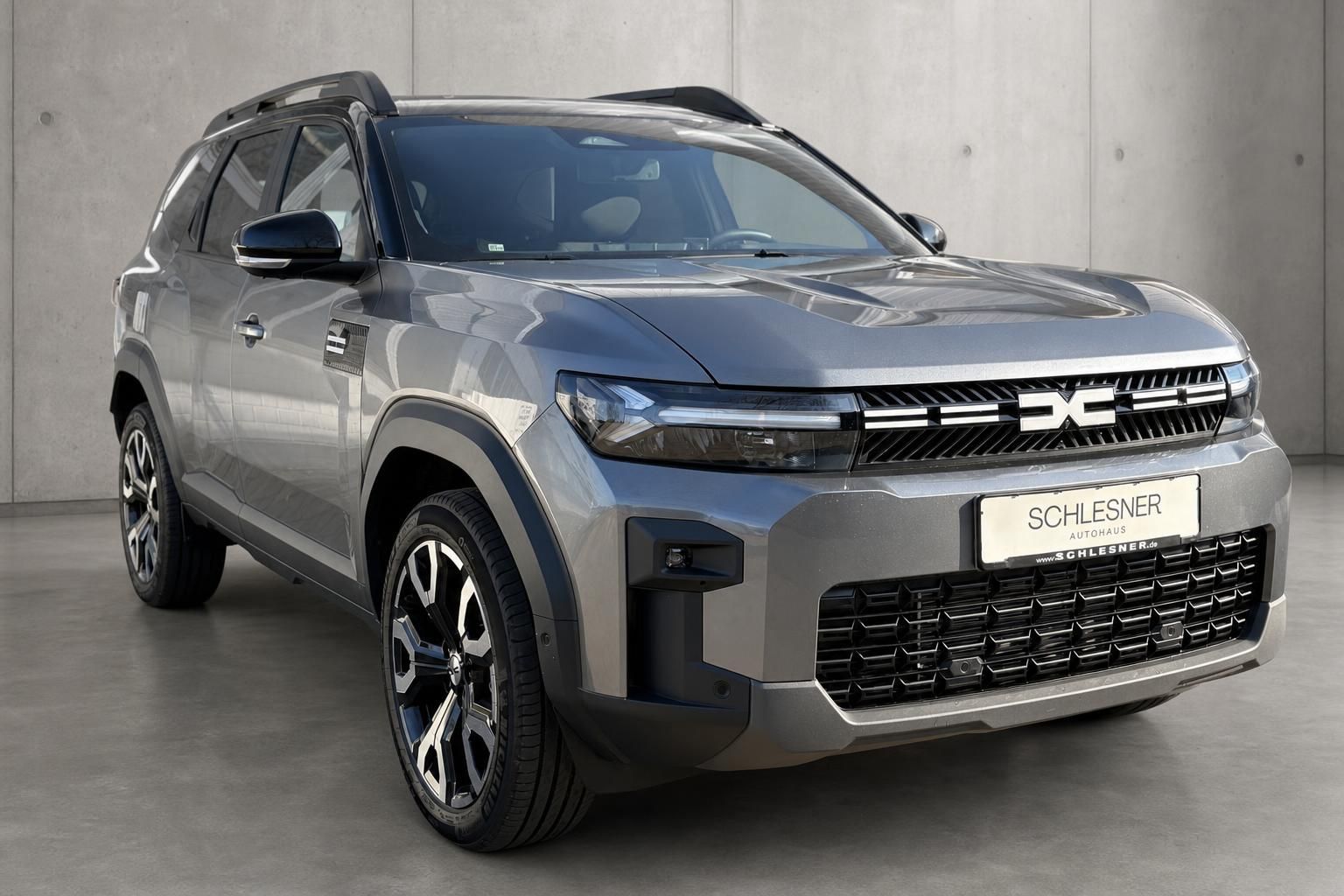 Grauer SUV von vorne mit LED-Scheinwerfern beim Autohaus Schlesner