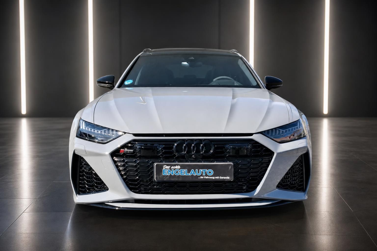 Audi RS6 Avant weiß direkte Frontansicht mit Wabengrill und Vierring-Logo im Showroom