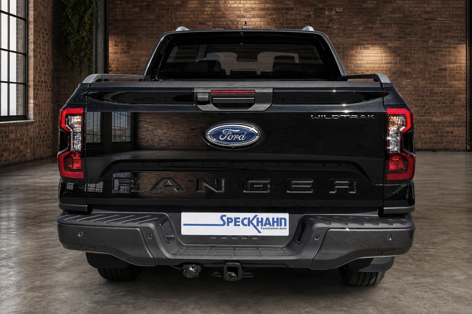 Ford Ranger Wildtrak schwarz Heckansicht in Halle mit Backsteinwand