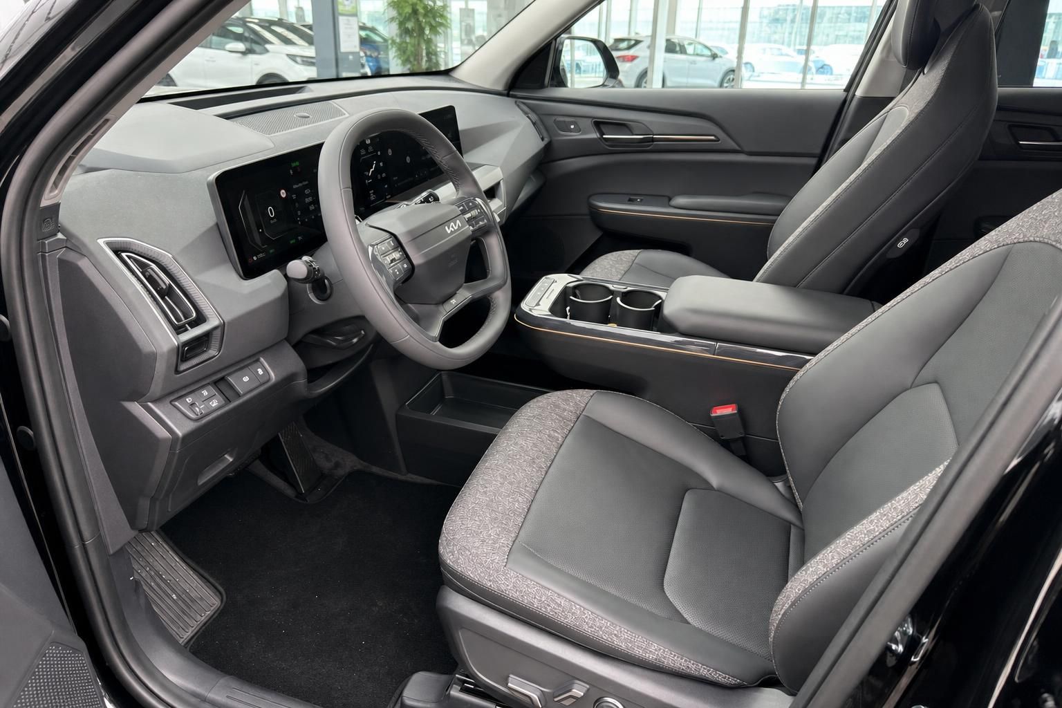 Kia EV5 Innenraum Vordersitze und Cockpit mit Lenkrad im Autohaus