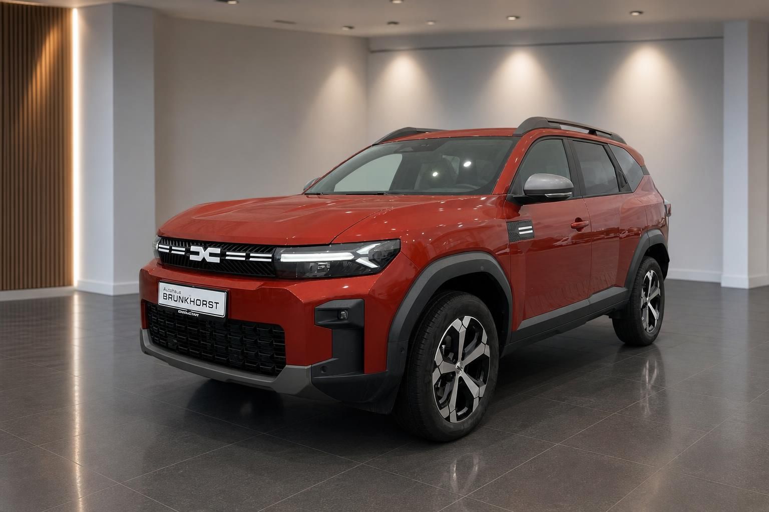 Dacia Bigster SUV in Orange - Seitenansicht mit modernem Design und Leichtmetallfelgen