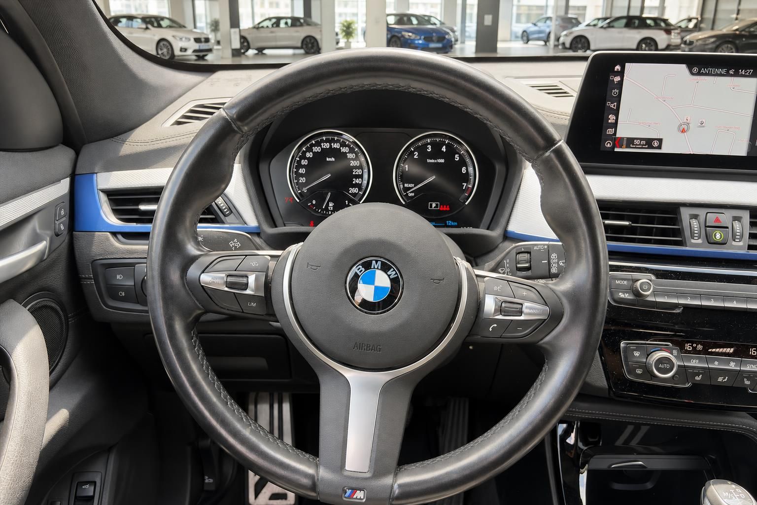 BMW X1 Lenkrad Nahaufnahme mit Tacho und Bordbildschirm