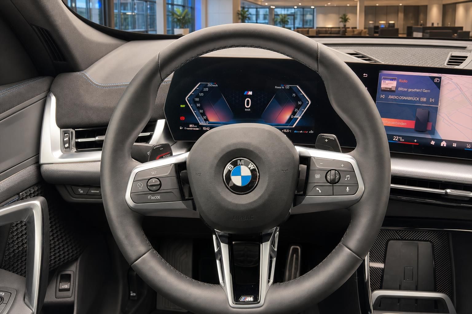 BMW Lenkrad Detailansicht mit digitalem Tacho und Infotainment