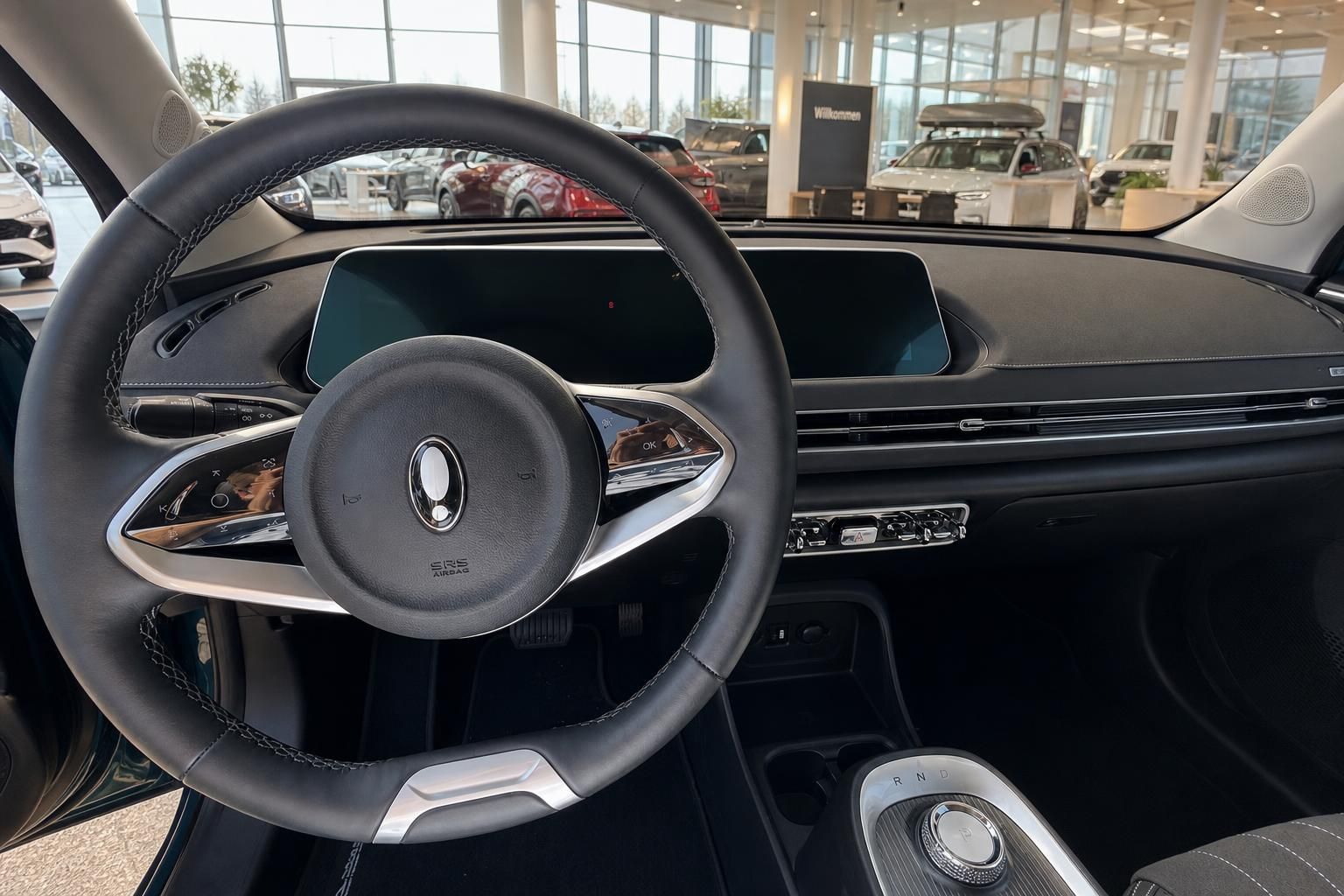 Ora Funky Cat Innenraum mit modernem Cockpit, Lenkrad und digitalen Displays im Autohaus
