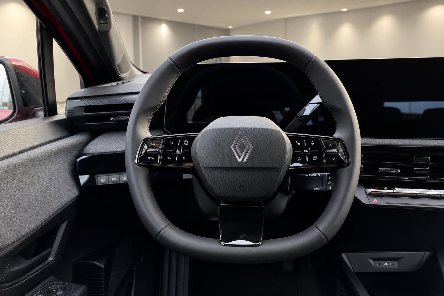 Renault Innenraum mit schwarzem Lenkrad und digitalen Bedienelementen im modernen Cockpit Design