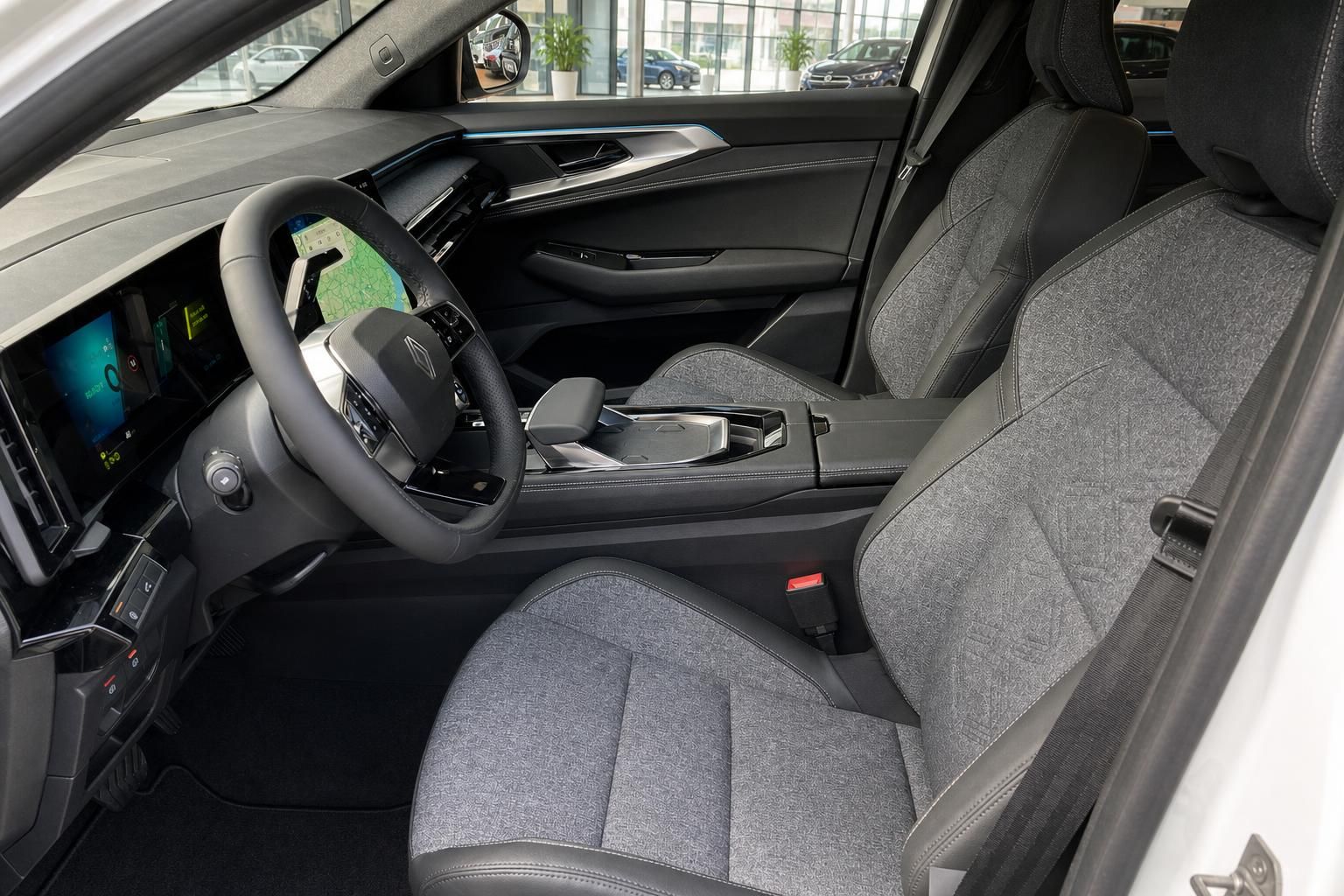 Fahrzeug Fahrersitz und Cockpit mit Renault-Lenkrad und grauer Stoffausstattung