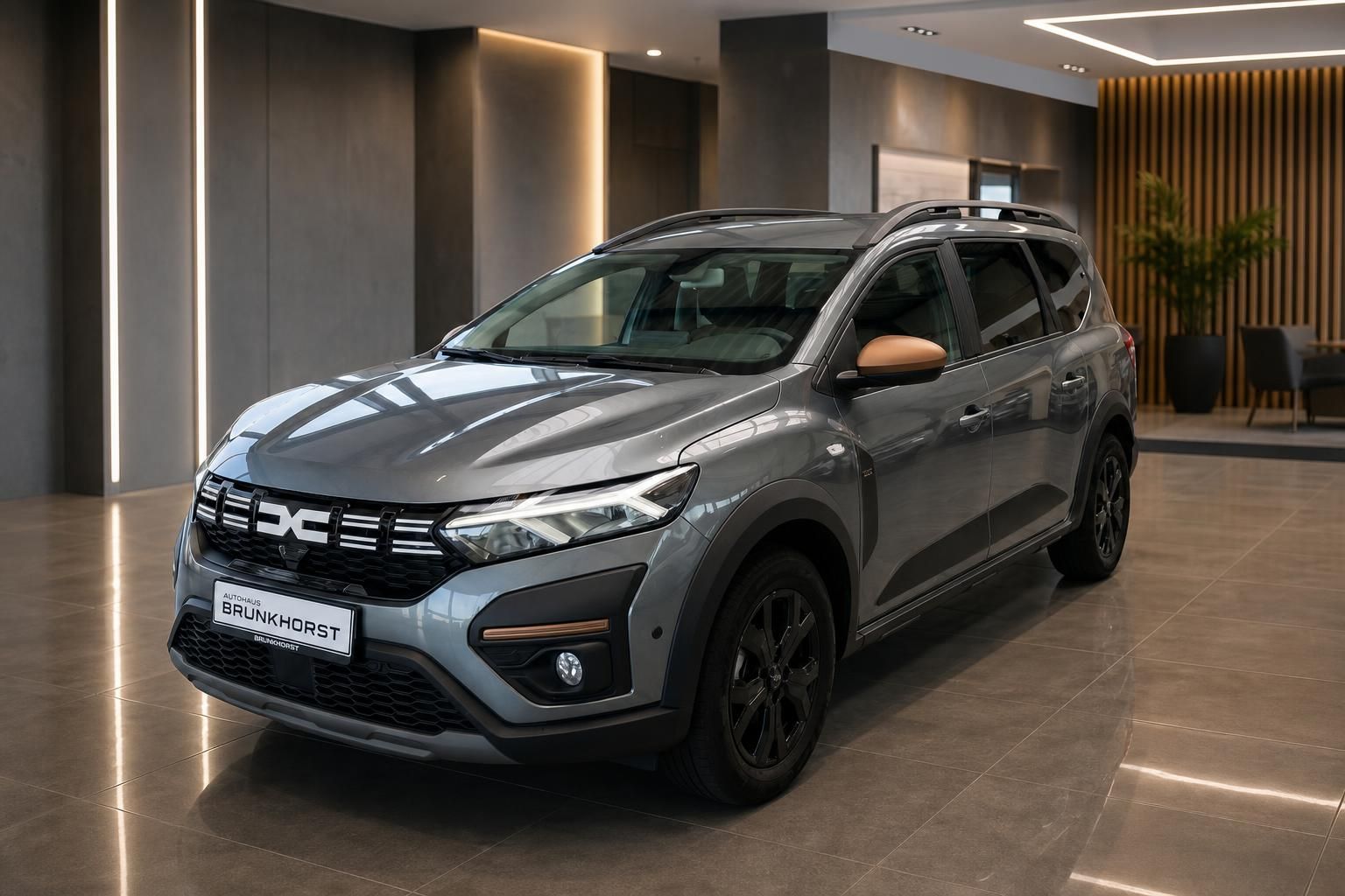 Dacia SUV grau Seitenansicht im modernen Autohaus Showroom