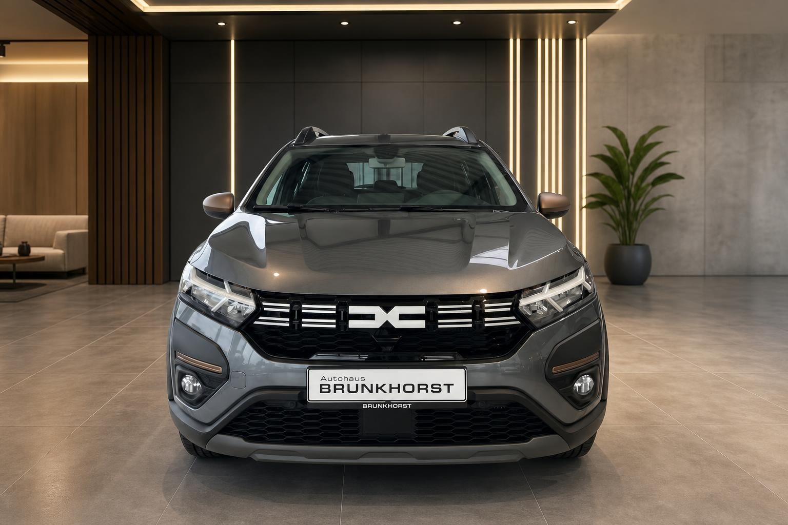 Dacia Fahrzeug grau Frontansicht mit Autohaus Brunkhorst Kennzeichenhalter
