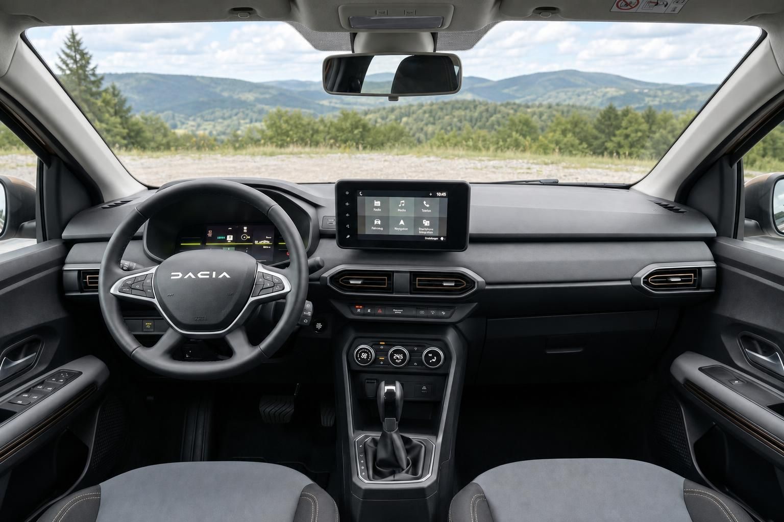 Dacia Innenraum schwarz grau mit Touchscreen und Landschaftsblick durch Windschutzscheibe