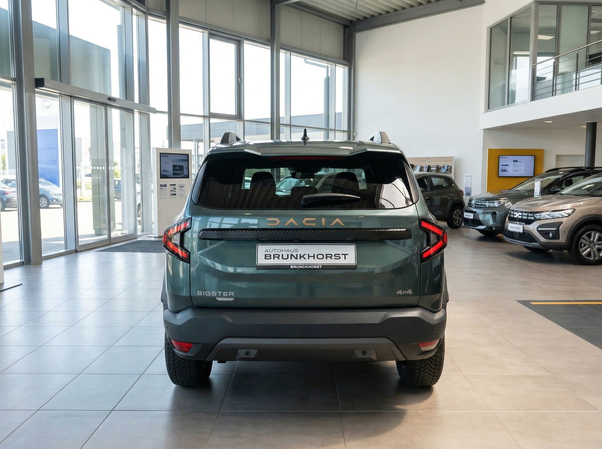 Dacia Bigster SUV Heckansicht in grün mit Autohaus Brunkhorst Kennzeichen im Showroom