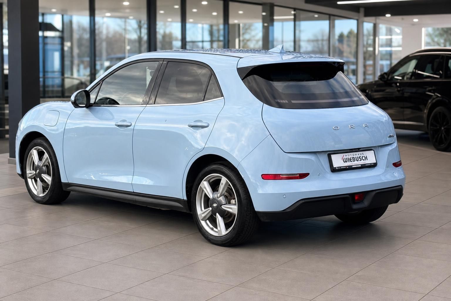 Hellblaues ORA Elektrofahrzeug Heckansicht mit Autohaus Wiebusch Kennzeichenhalter