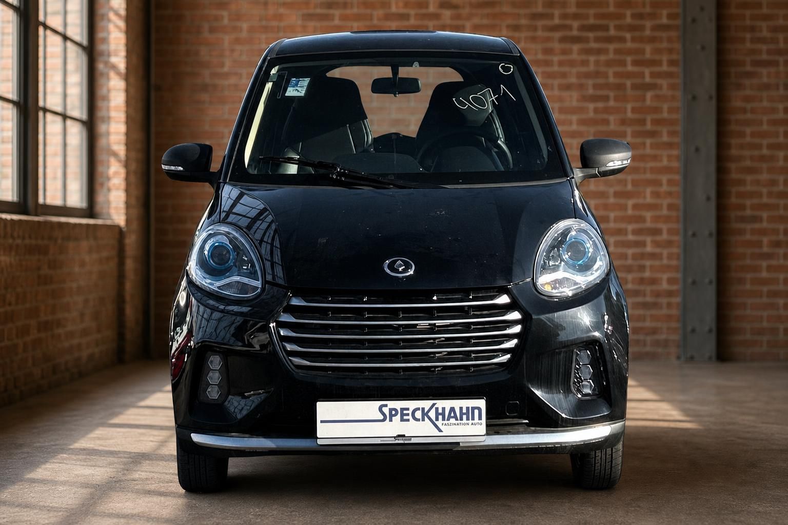 Schwarzer Kleinwagen frontal fotografiert mit markanter Kühlergrill-Front
