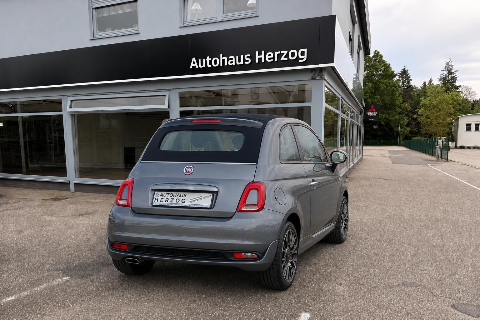Fiat 500 grau metallic Heckansicht vor Autohaus Herzog