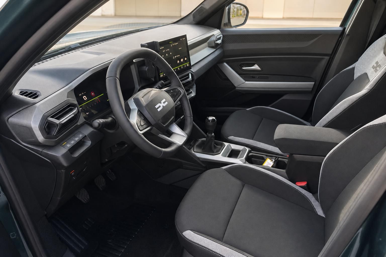 Dacia Innenraum mit schwarzen Sitzen, modernem Cockpit und Digital-Display - Fahrerperspektive