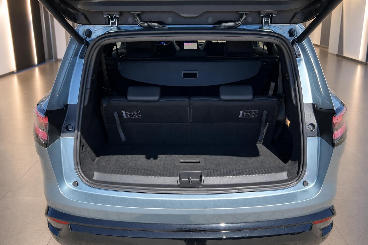 Geöffneter Kofferraum eines blauen SUV mit großem Ladevolumen im Autohaus